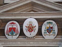 Escudo del cardenal Tarcisio Bertone, del Papa Benedicto XVI, y del obispo Raffaello Martinelli en la fachada de la catedral.